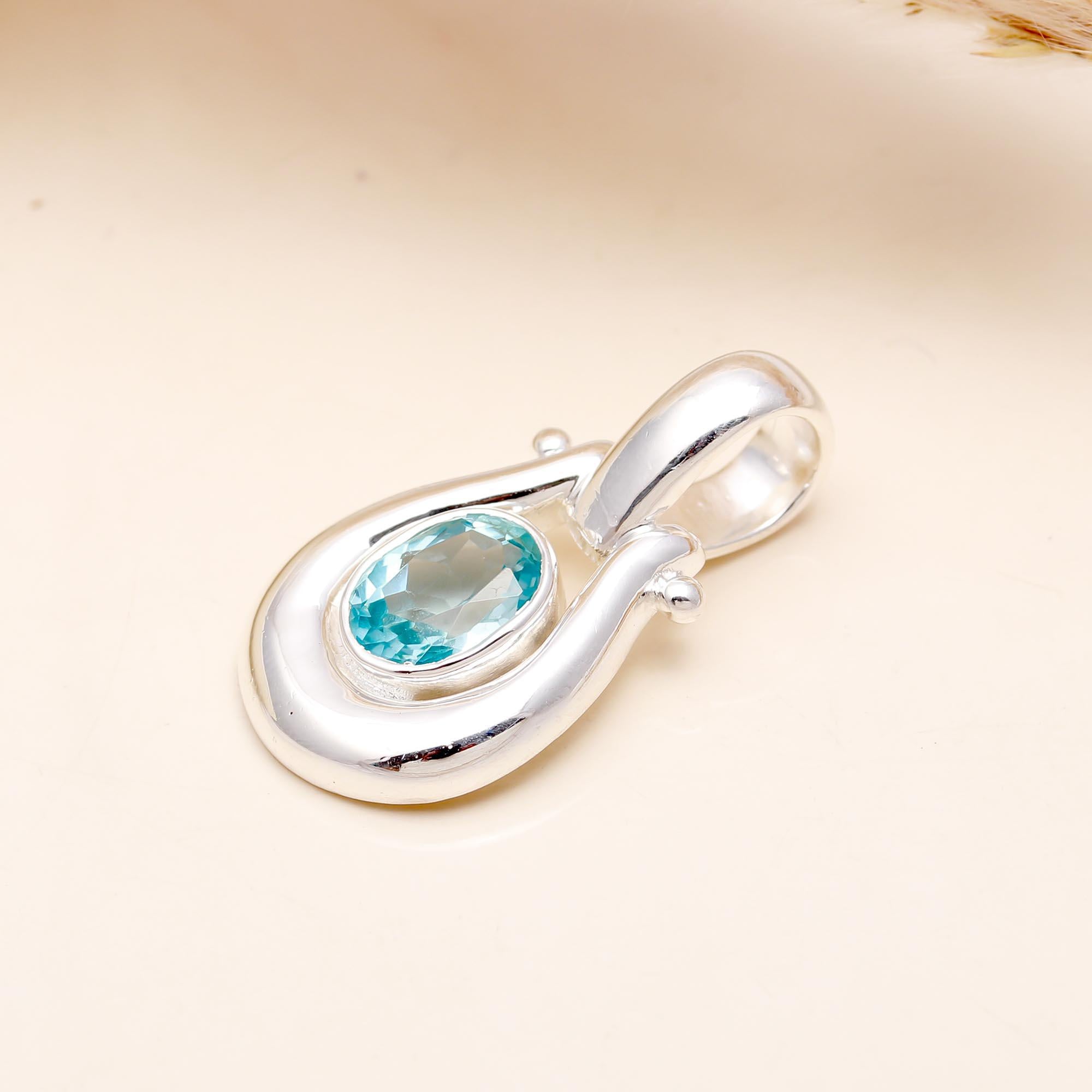 The Azure Loop: Blue Topaz Modern Silver Pendant