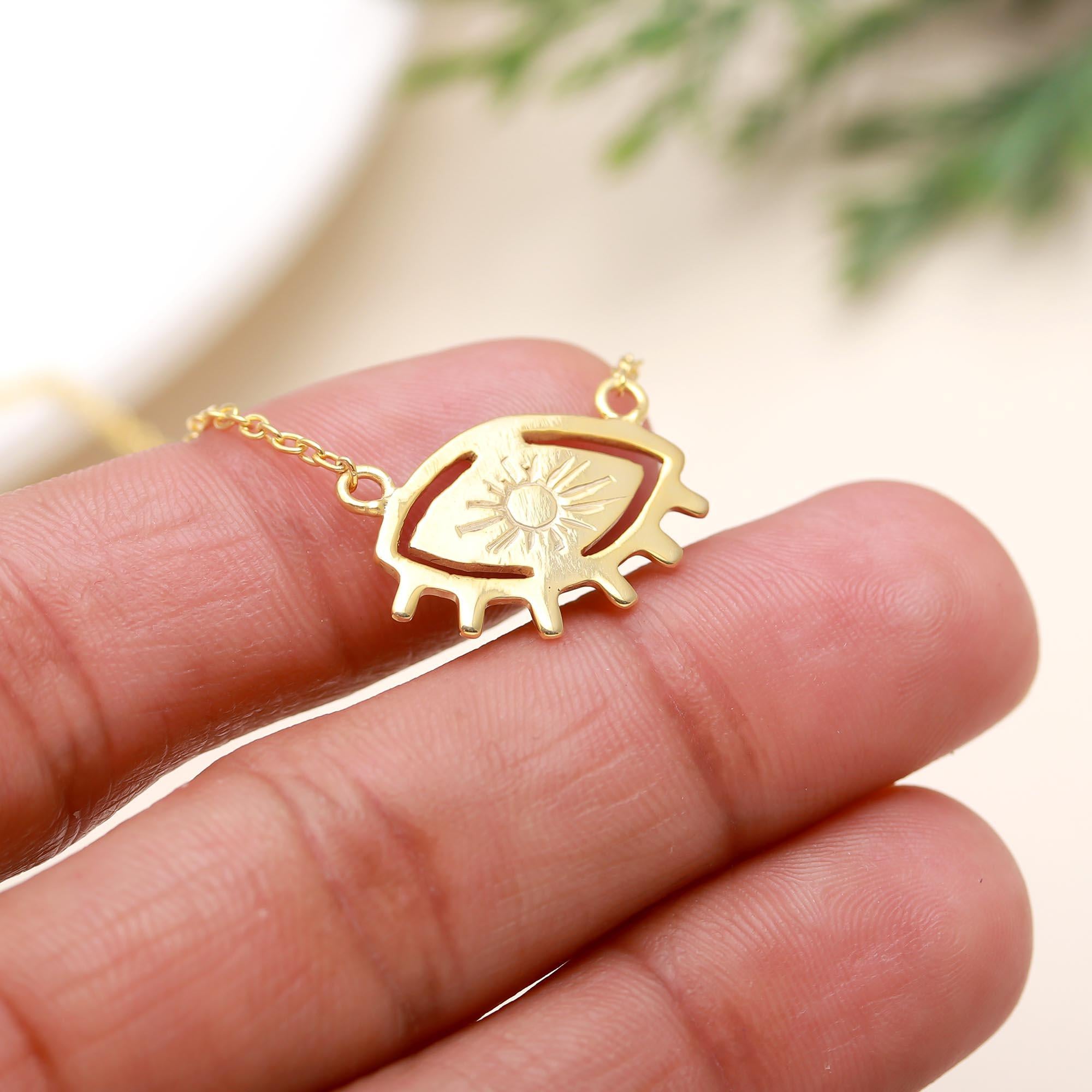 The Solar Gaze: Gold Eye & Sunburst Pendant Necklace