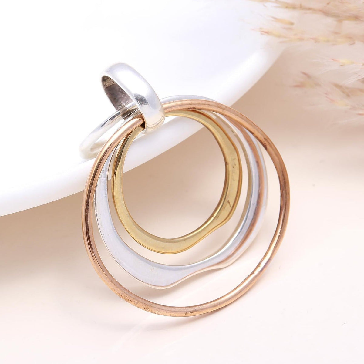 Jewelry with interlocking rings on a neutral background