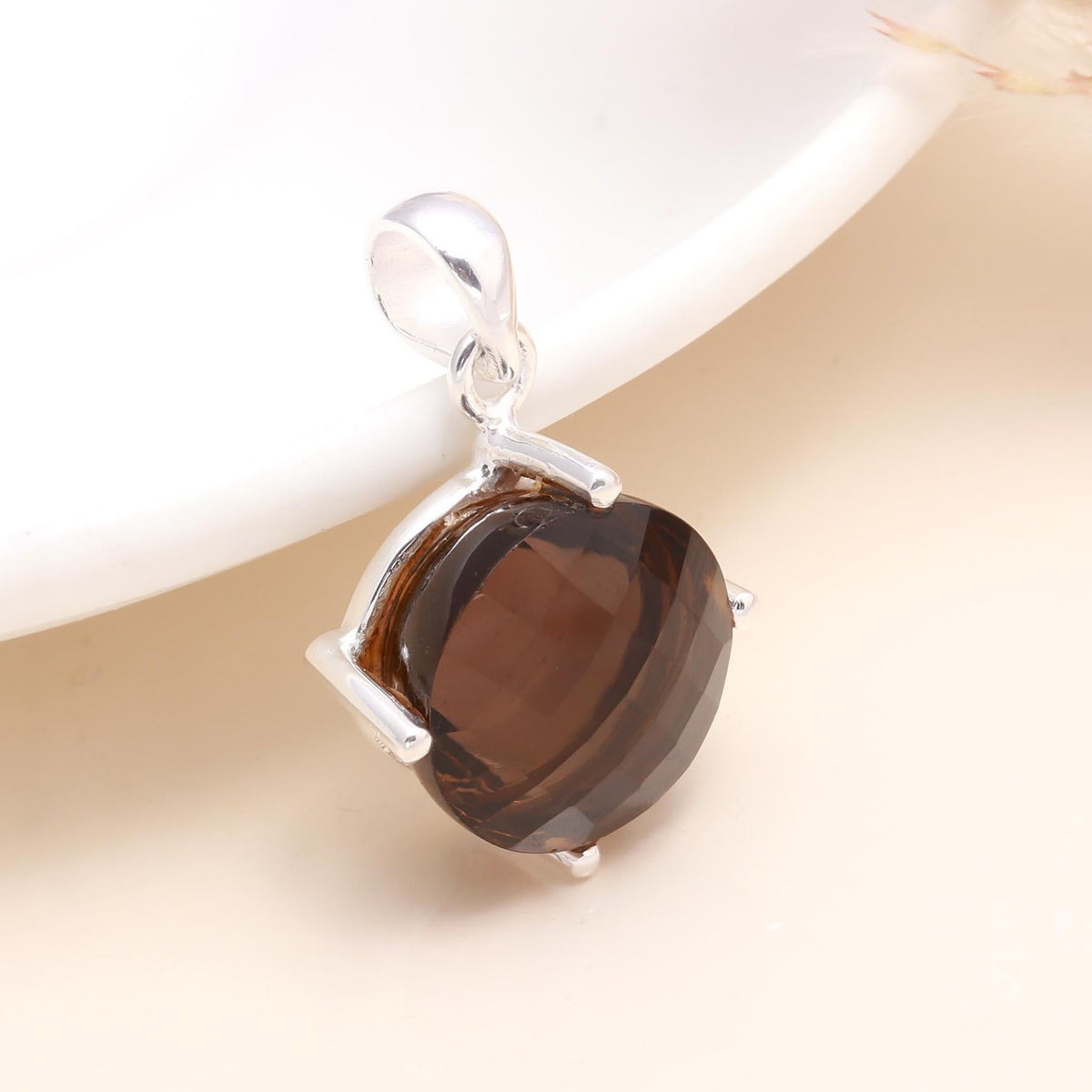 A round smoky quartz gemstone pendant set in a 925 sterling silver mounting, displayed against a light background.