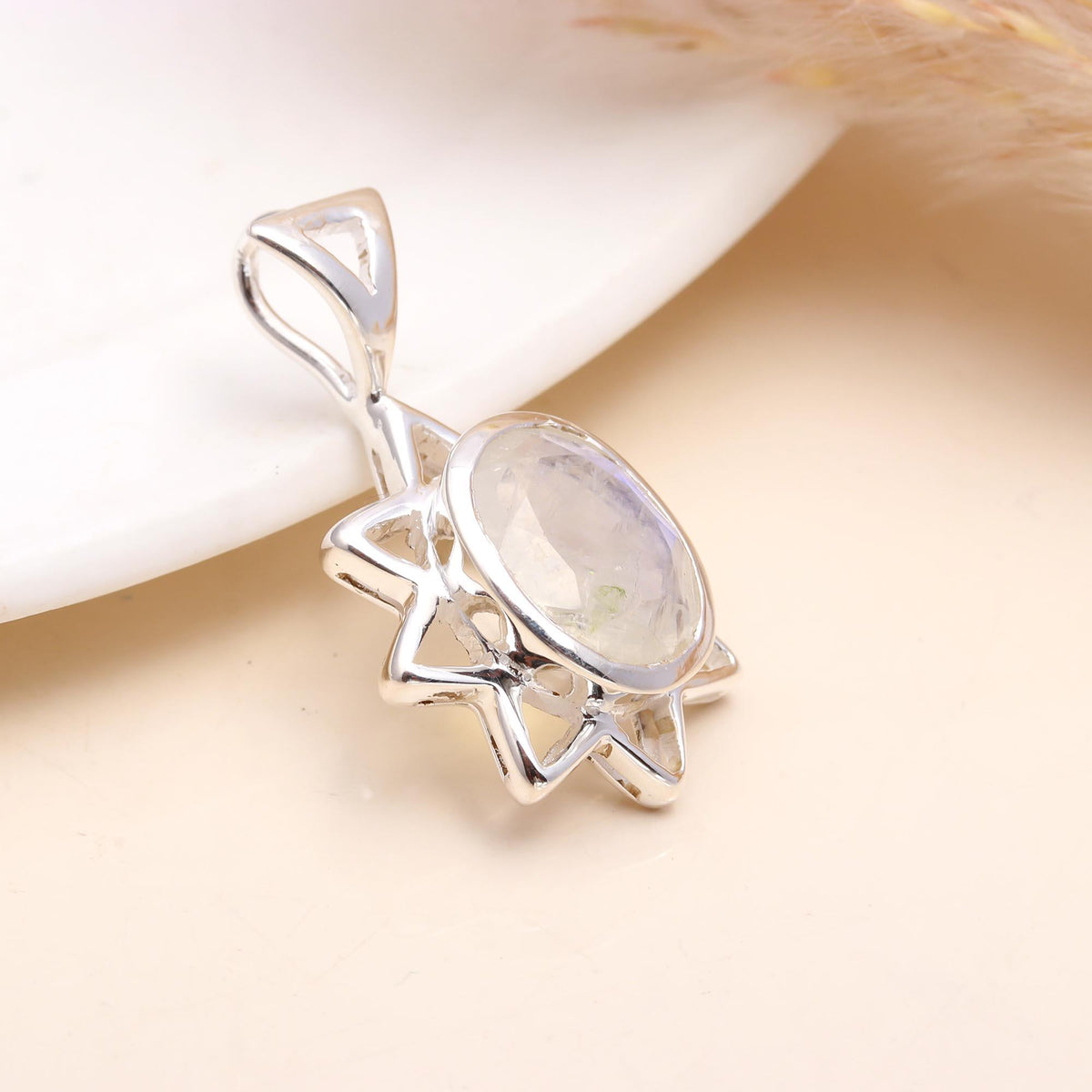 The Flame Star: Radiant Moonstone Silver Starburst Charm