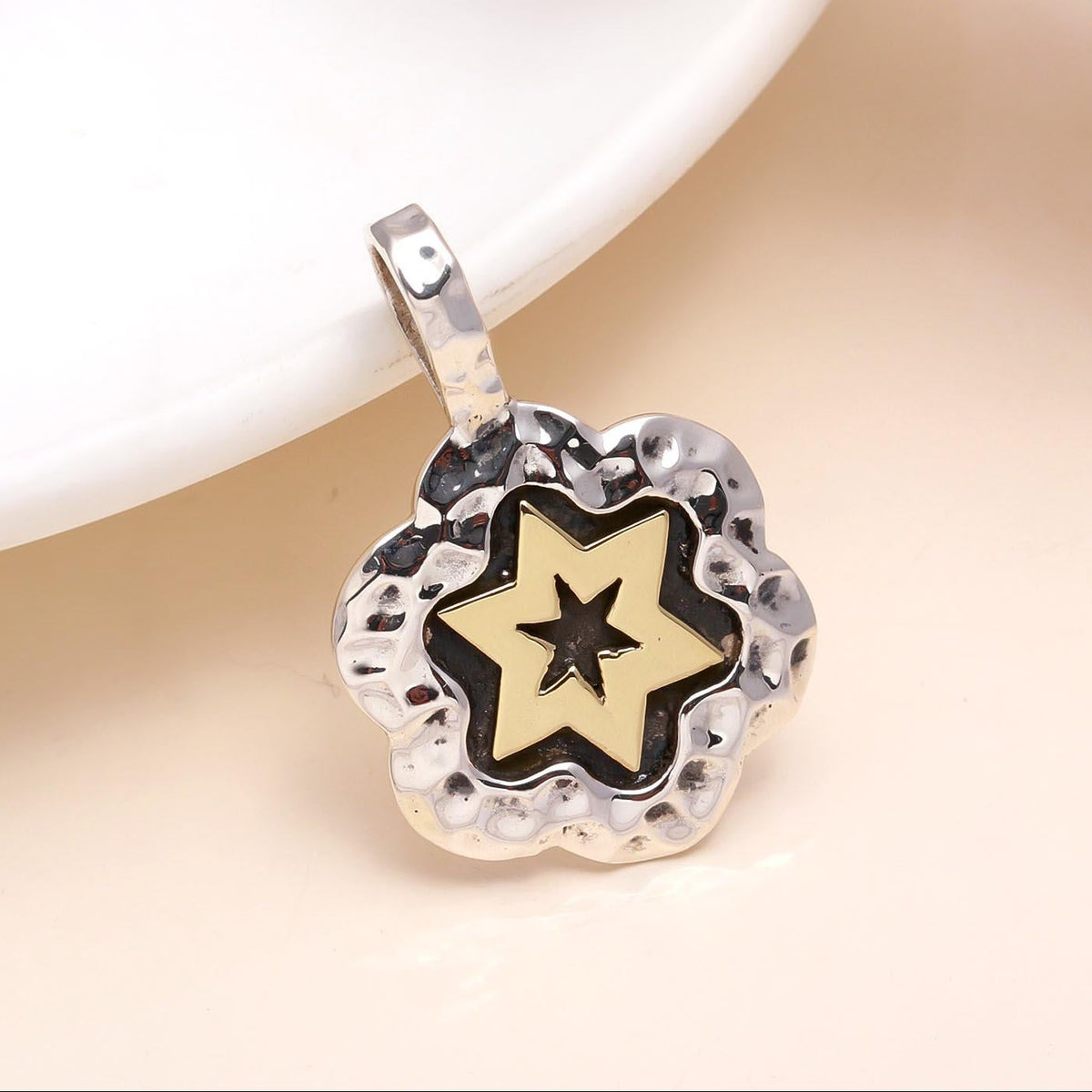 A 925 sterling silver hammered two-tone star pendant with gold-tone accents, displayed against a neutral background.