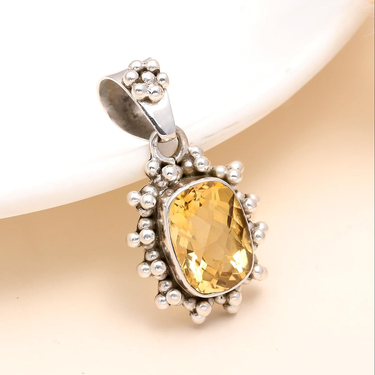 A 925 Sterling Silver Citrine Pendant with a radiant golden-yellow natural citrine gemstone, set in a silver mounting with small silver beads around the edge, displayed against a neutral background.