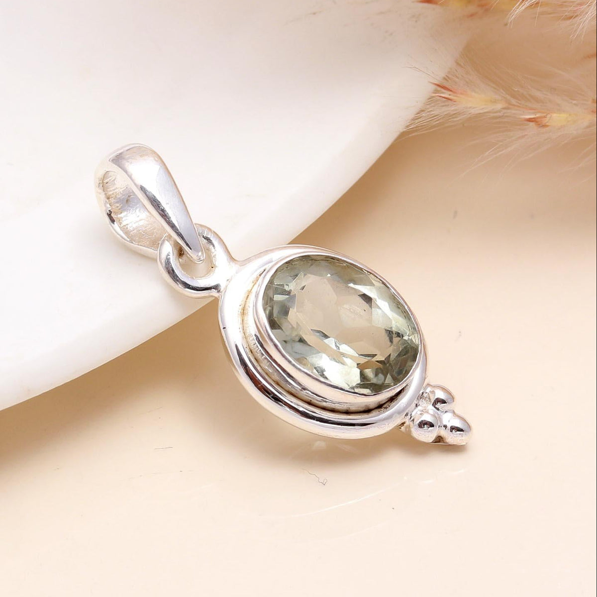 A 925 Sterling Silver Vintage Oval Green Quartz Pendant placed on a white surface with a soft shadow.