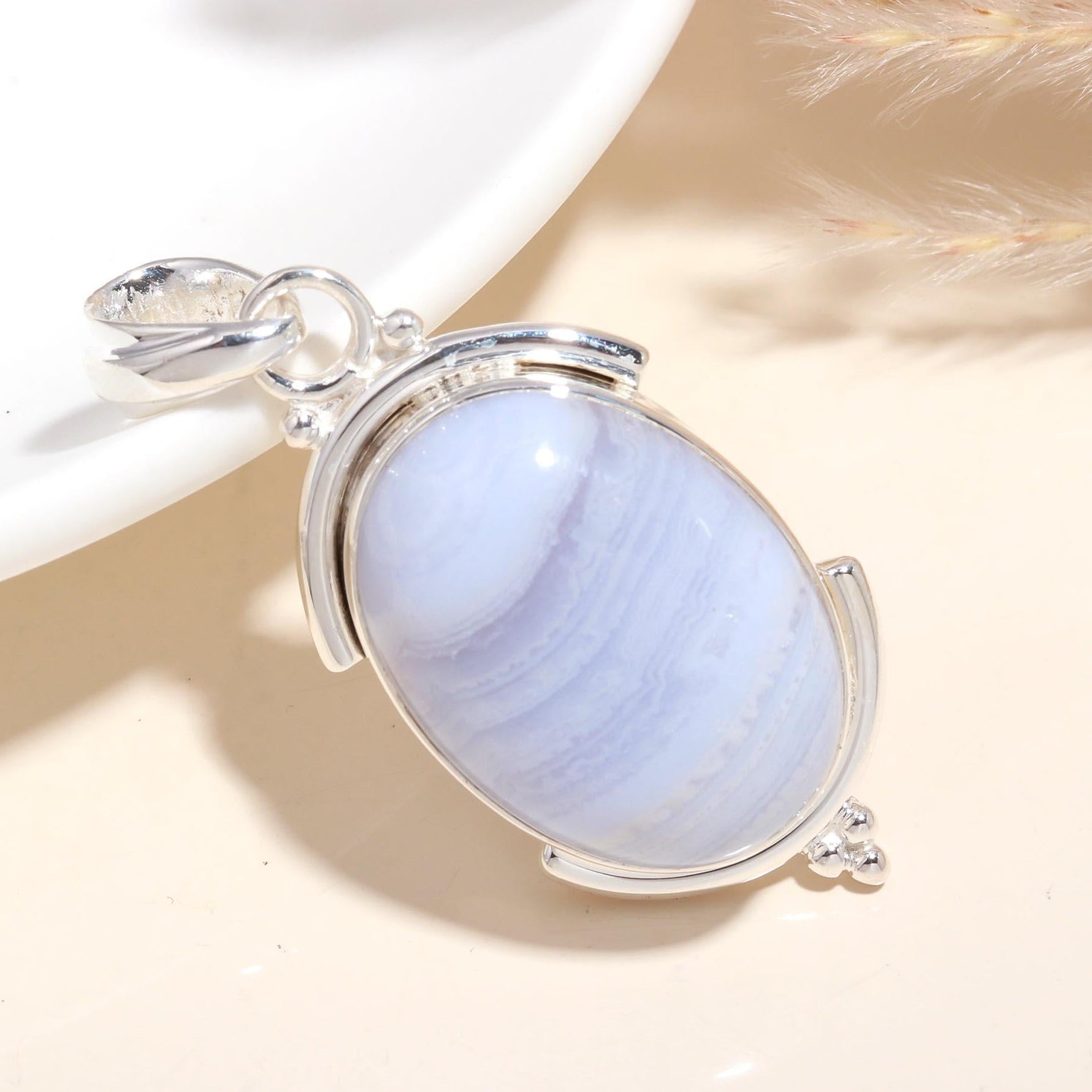 A 925 Sterling Silver Oval Blue Lace Agate Pendant with a handmade boho design, displayed against a neutral background.