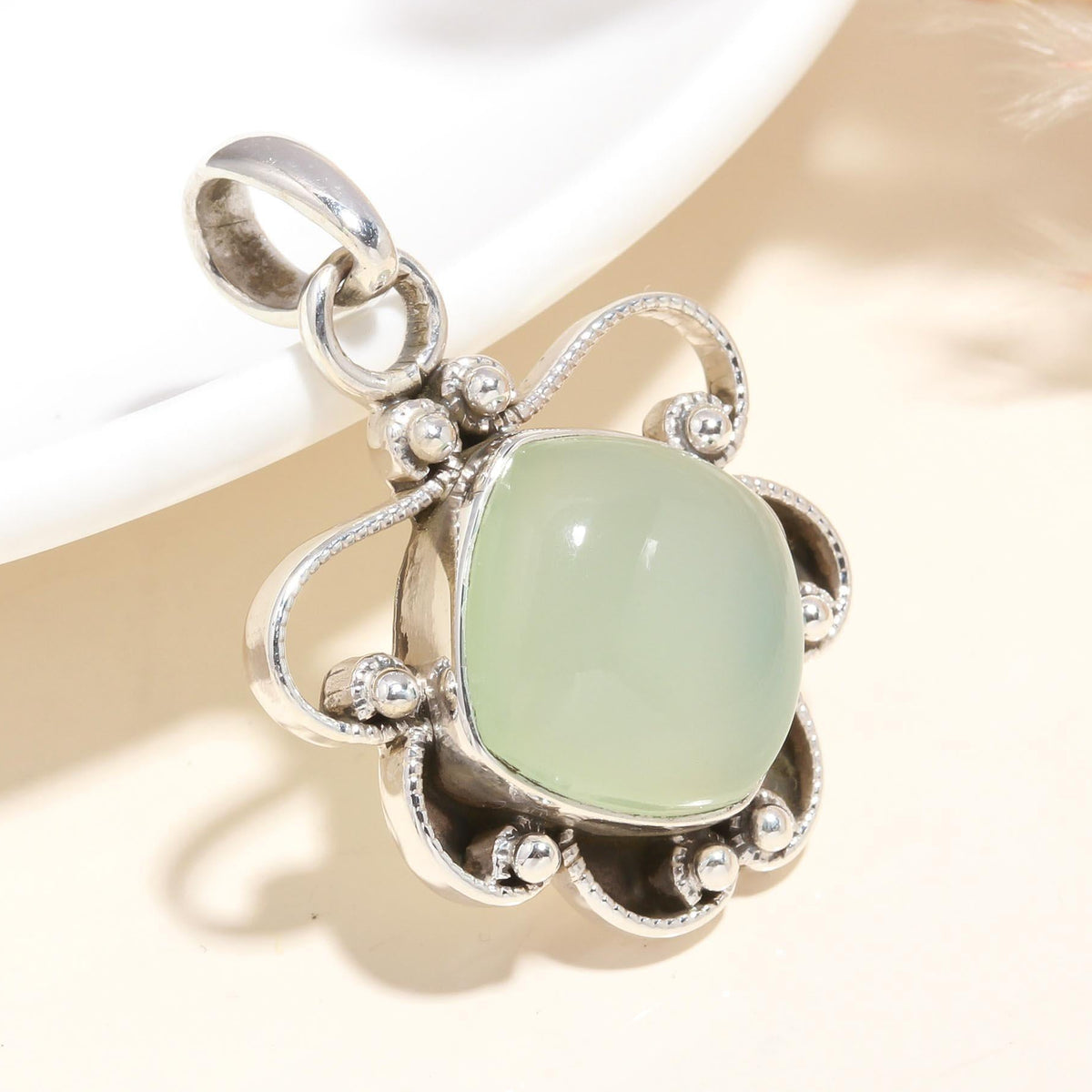 A 925 Sterling Silver pendant with a natural green chalcedony gemstone, featuring vintage-style filigree silverwork.