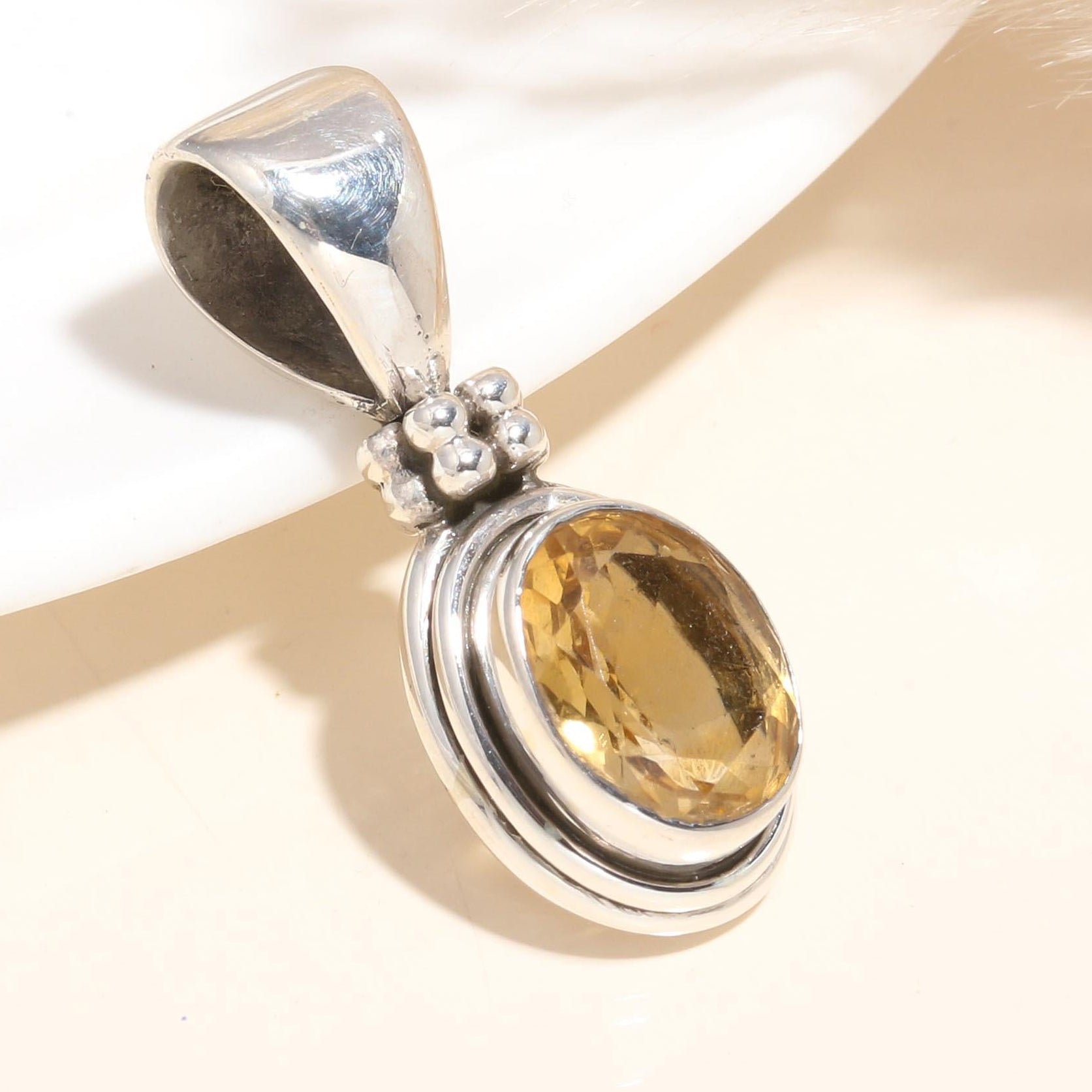 A 925 Sterling Silver Citrine Pendant with a handmade boho style setting, featuring a golden yellow citrine gemstone.
