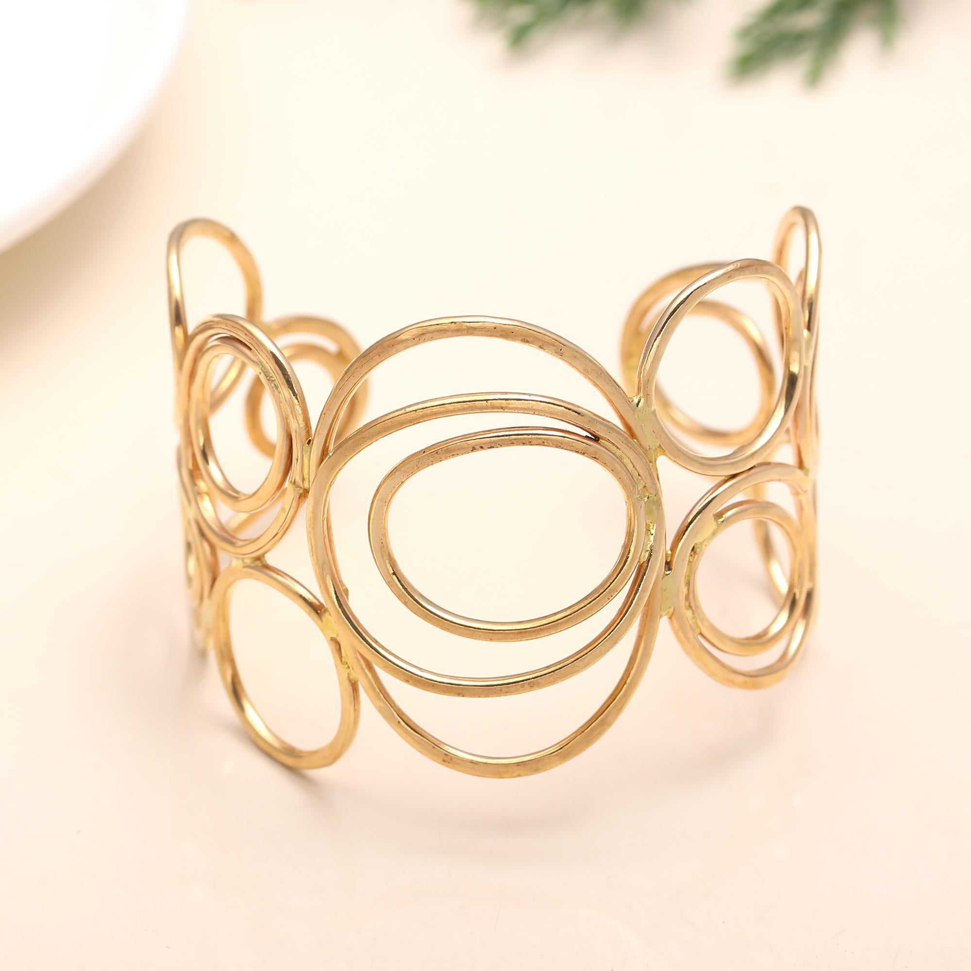 Gold bracelet with interlocking circular design on a light background