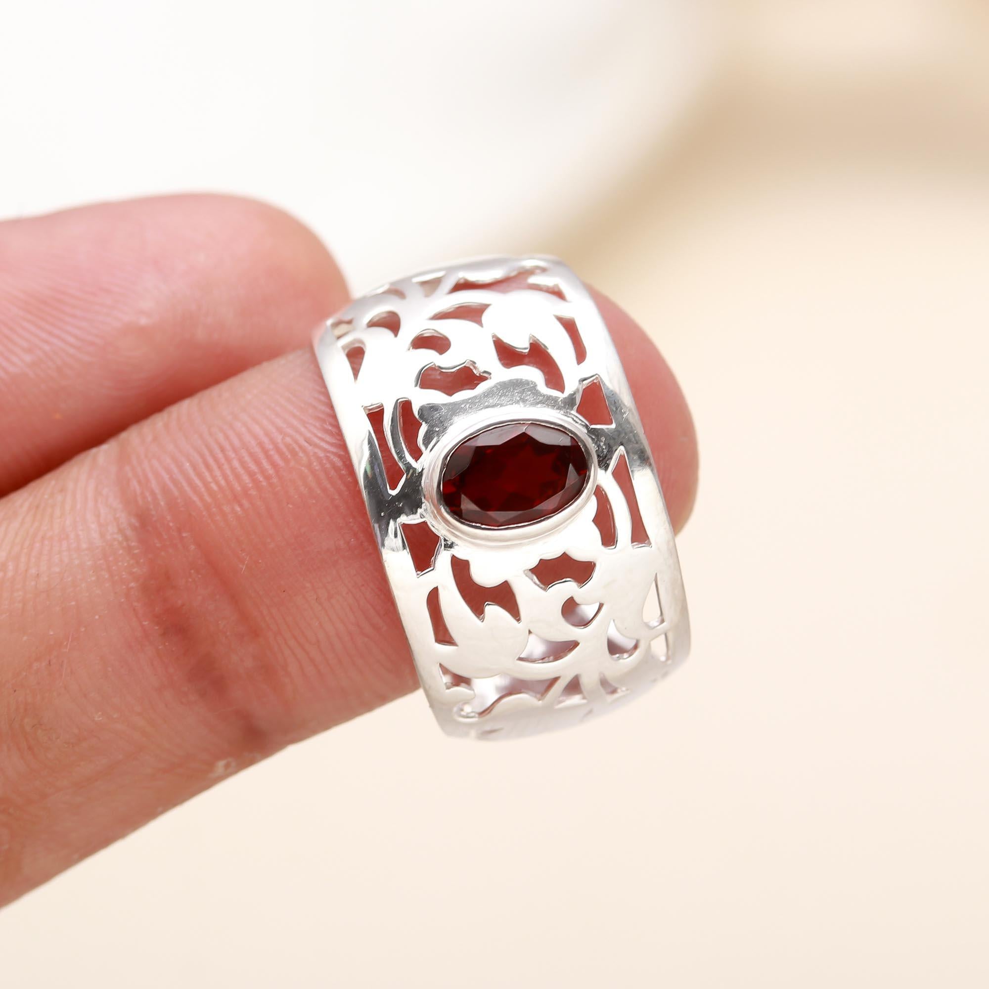 Elegant sterling silver band ring with red garnet gemstone