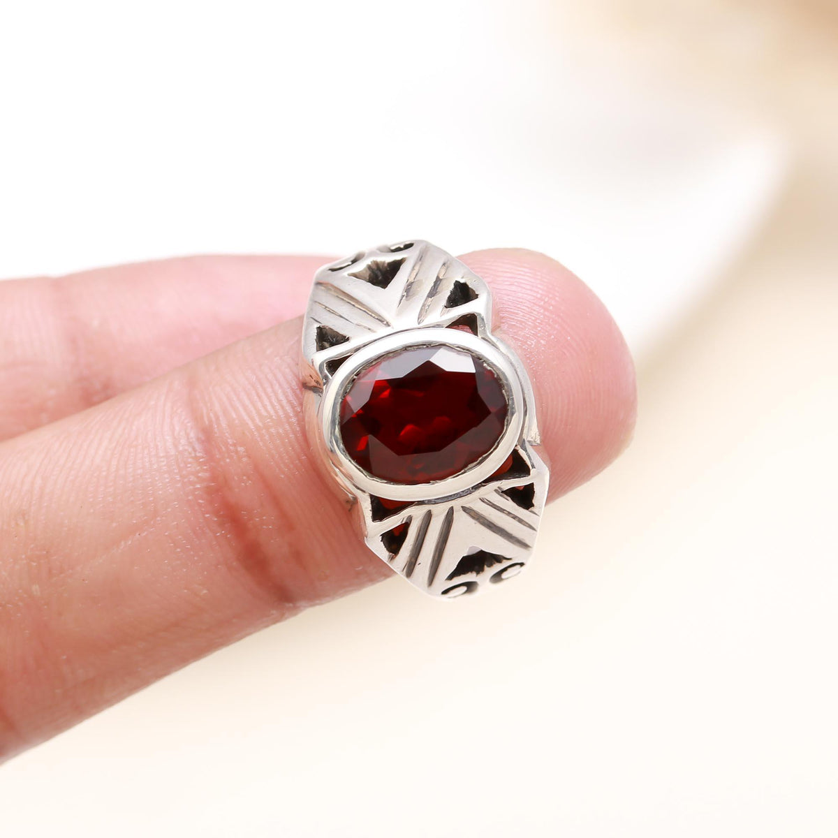 Elegant oval garnet gemstone ring on finger