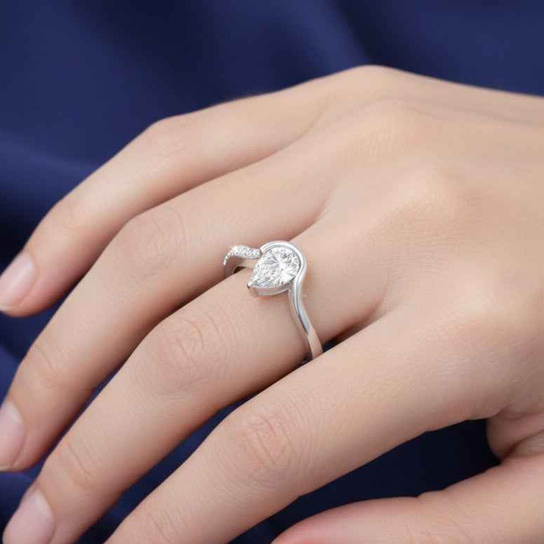 The Fluid Pear: Contemporary Bypass Moissanite Ring