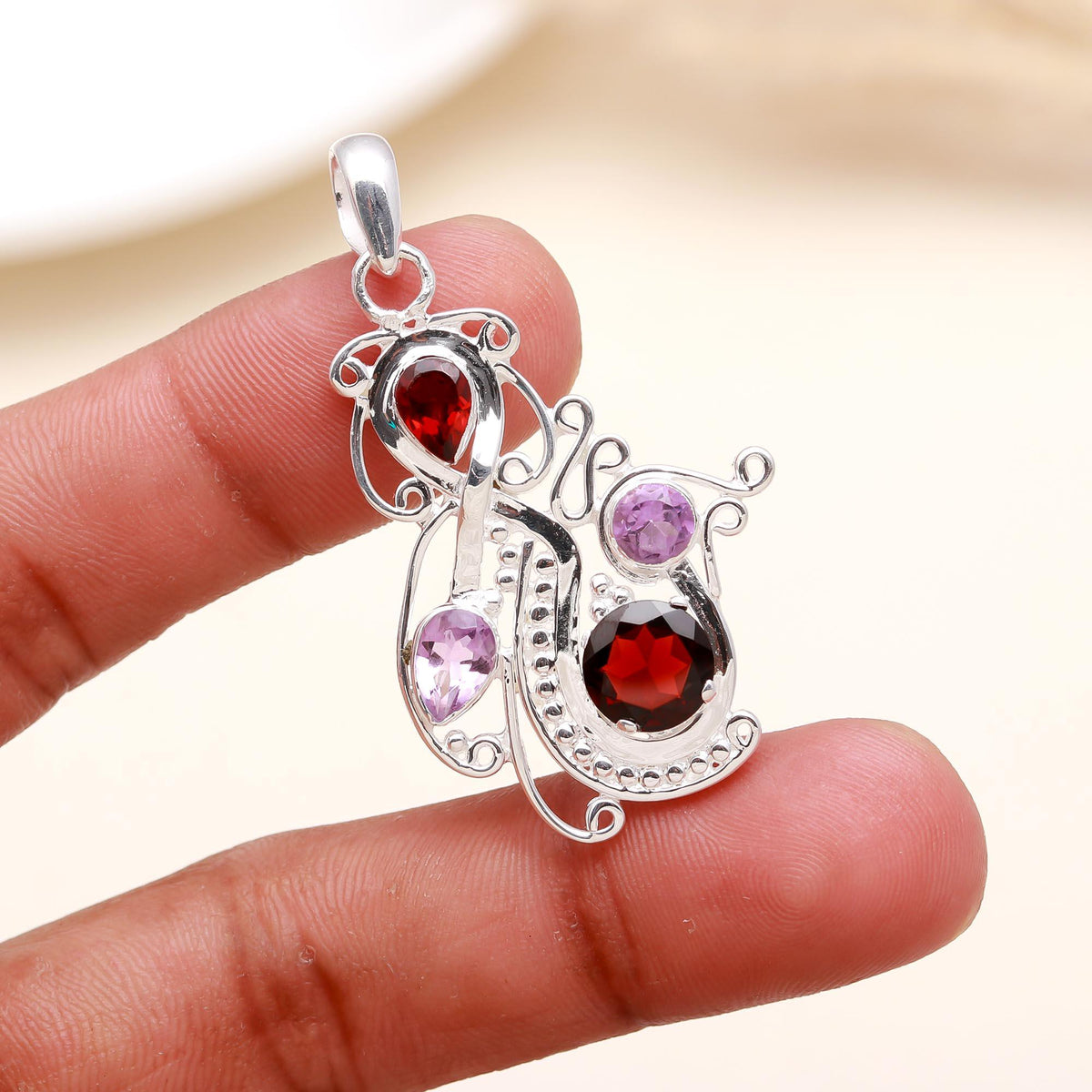 The Mystic Swirl: Garnet & Amethyst Abstract Curve Pendant