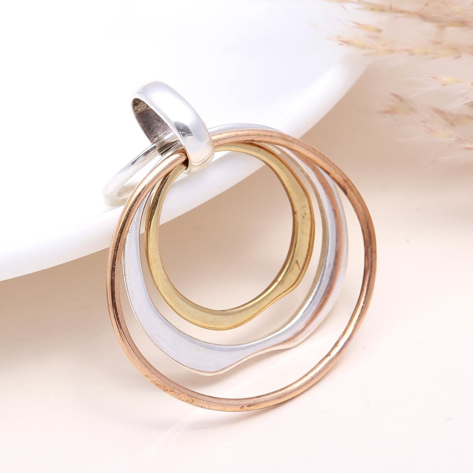 Jewelry with interlocking rings on a neutral background