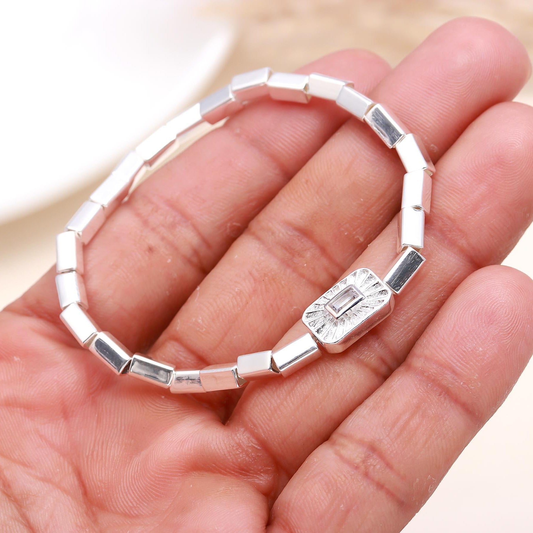 Silver bracelet with a diamond on a hand