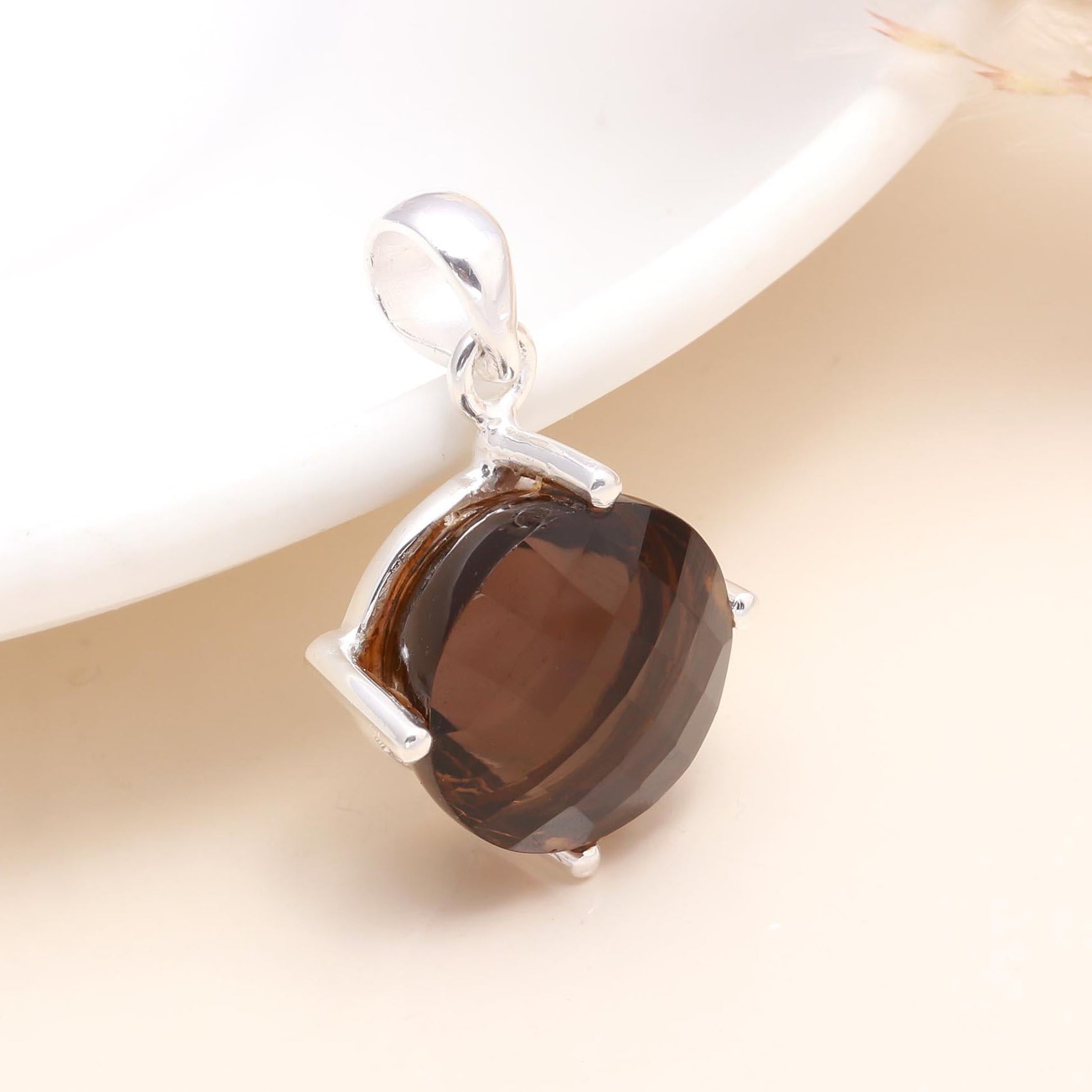 A round smoky quartz gemstone pendant set in a 925 sterling silver mounting, displayed against a light background.