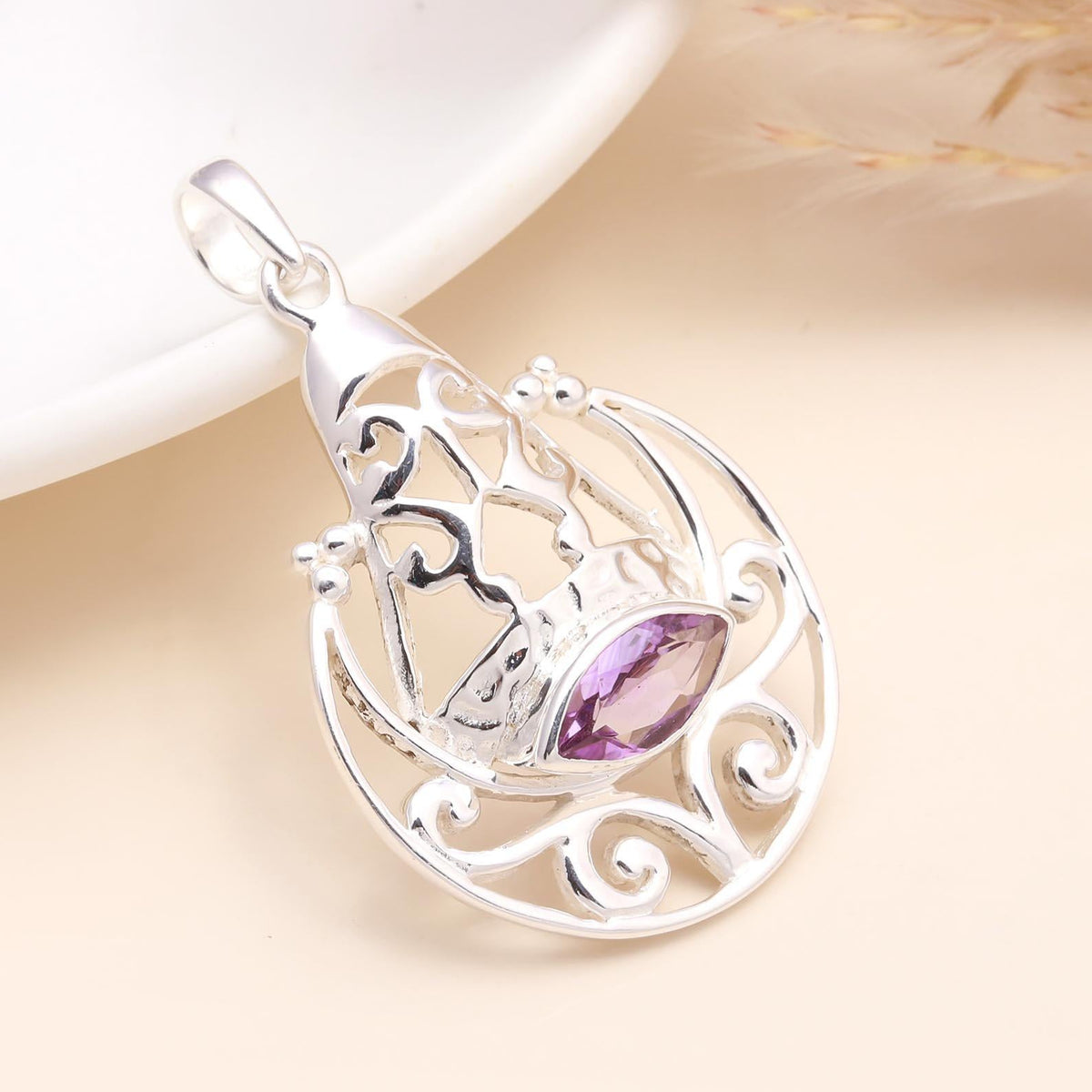A 925 Sterling Silver Amethyst Moon & Star Pendant with a purple gemstone, set against a neutral background.