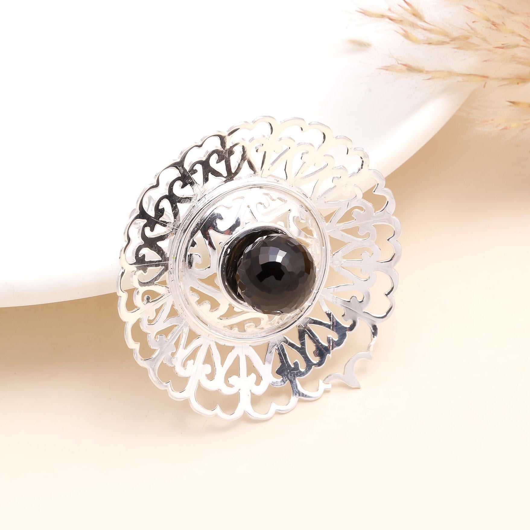 A 925 Sterling Silver Filigree Smoky Quartz Boho Pendant with intricate designs around the gemstone, displayed against a light background.