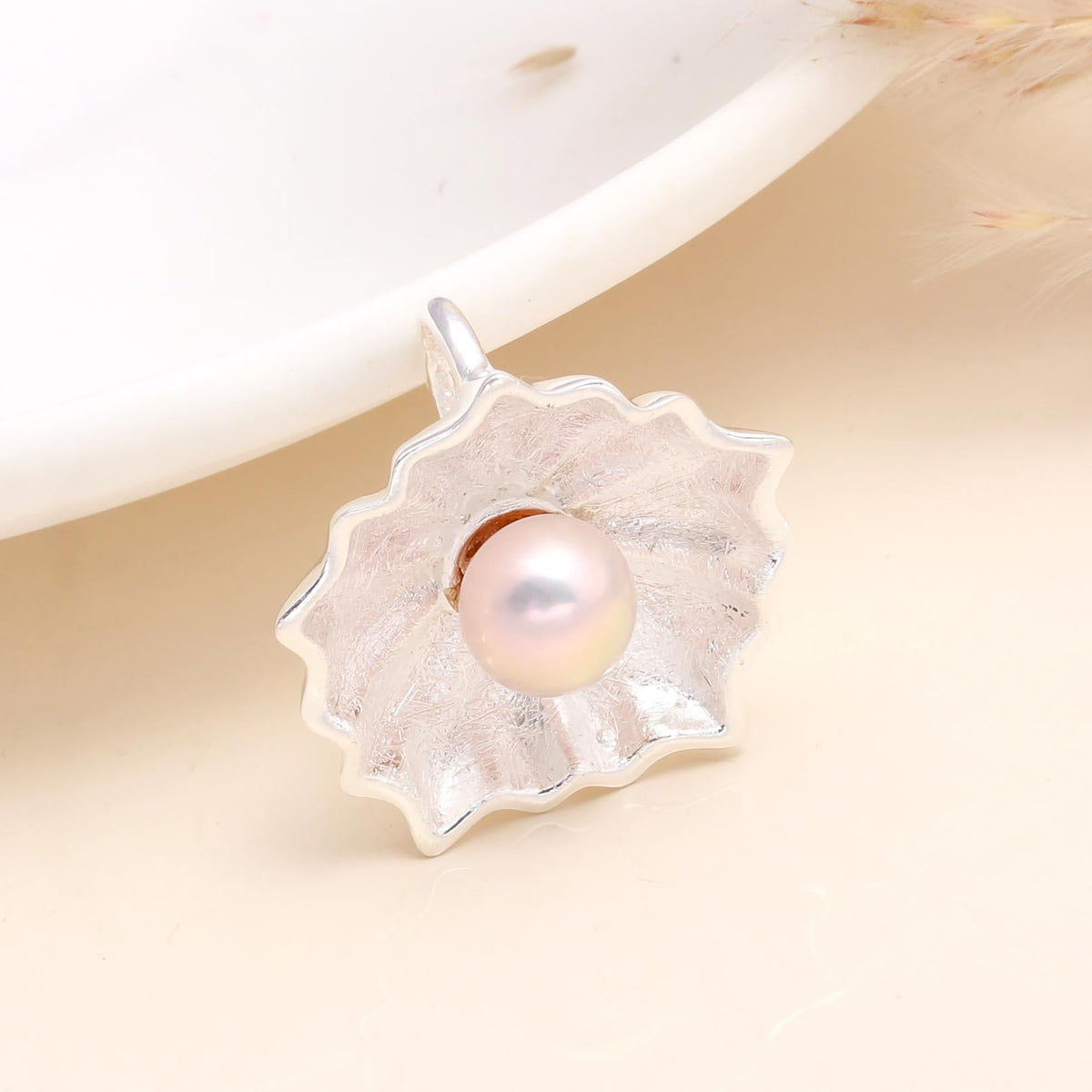 A 925 Sterling Silver Pink Pearl Flower Pendant displayed against a neutral background, with a natural pink freshwater pearl at the center of a floral design.