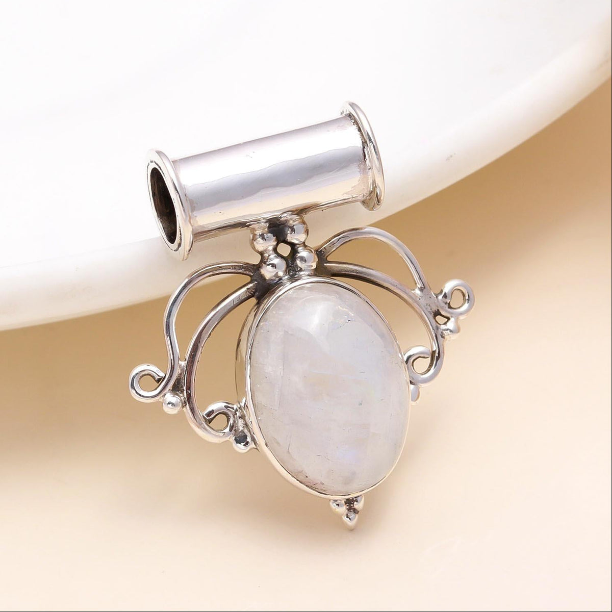 A 925 sterling silver pendant featuring a moonstone gemstone with intricate filigree detailing.