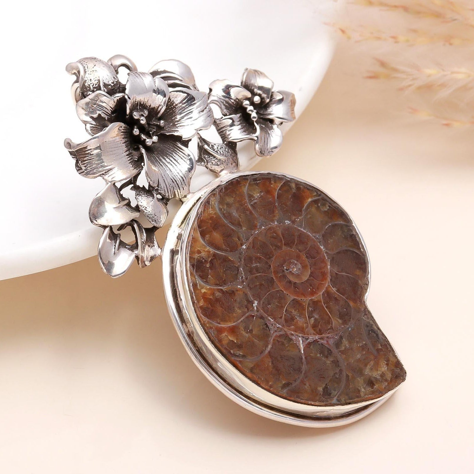 A 925 Sterling Silver pendant featuring a raw agate druzy crystal with floral designs on the side, displayed against a neutral background.