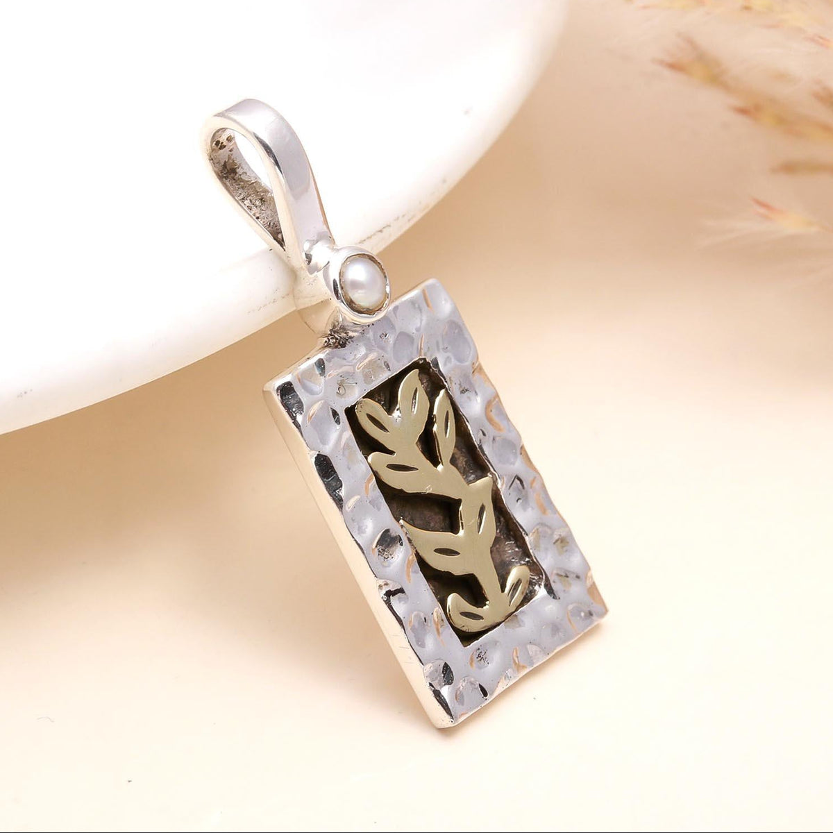 A 925 Sterling Silver Leaf Design Pendant with intricate leaf motif, presented against a neutral background.
