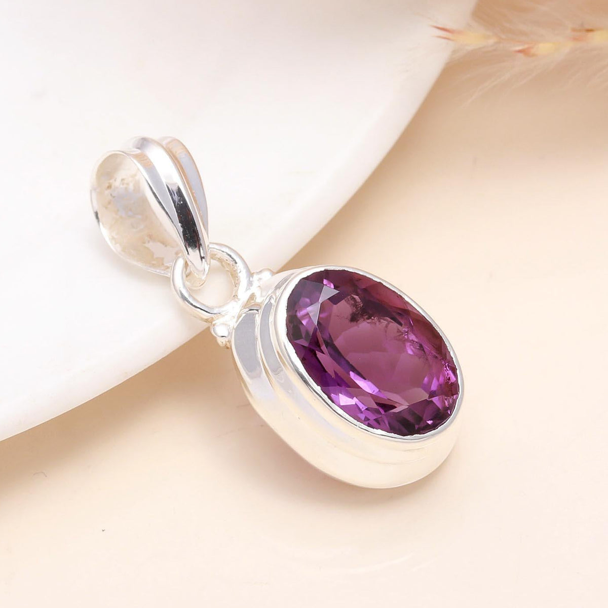 A 925 Sterling Silver Pendant with an oval-cut Amethyst gemstone, displayed against a neutral background.