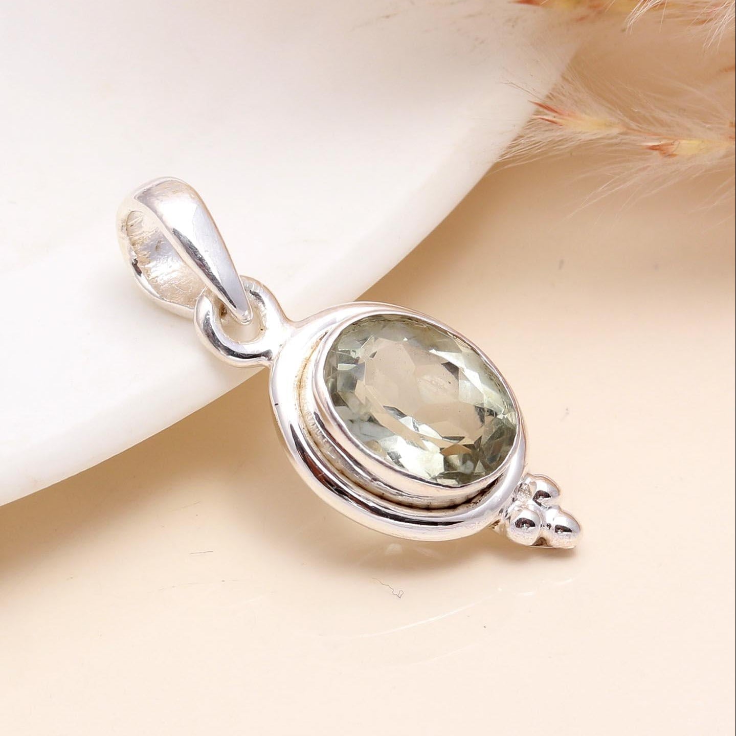 A 925 Sterling Silver Vintage Oval Green Quartz Pendant placed on a white surface with a soft shadow.