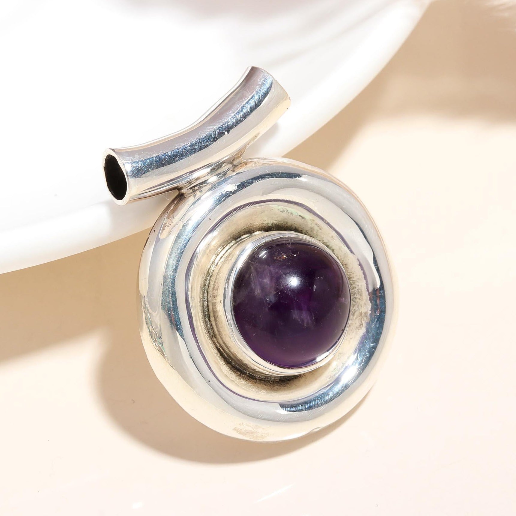 A 925 sterling silver dome pendant featuring a natural amethyst gemstone, presented against a neutral background.