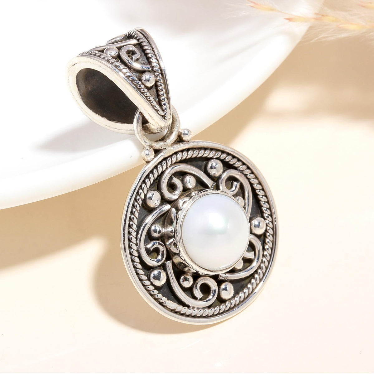 A 925 Sterling Silver Vintage Filigree Pearl Pendant with intricate silverwork around the natural freshwater pearl, displayed against a neutral background.