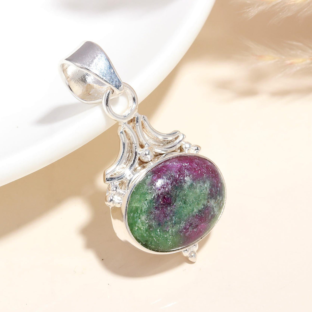 A 925 Sterling Silver pendant featuring an oval-cut natural Ruby Zoisite gemstone, displayed against a neutral background.