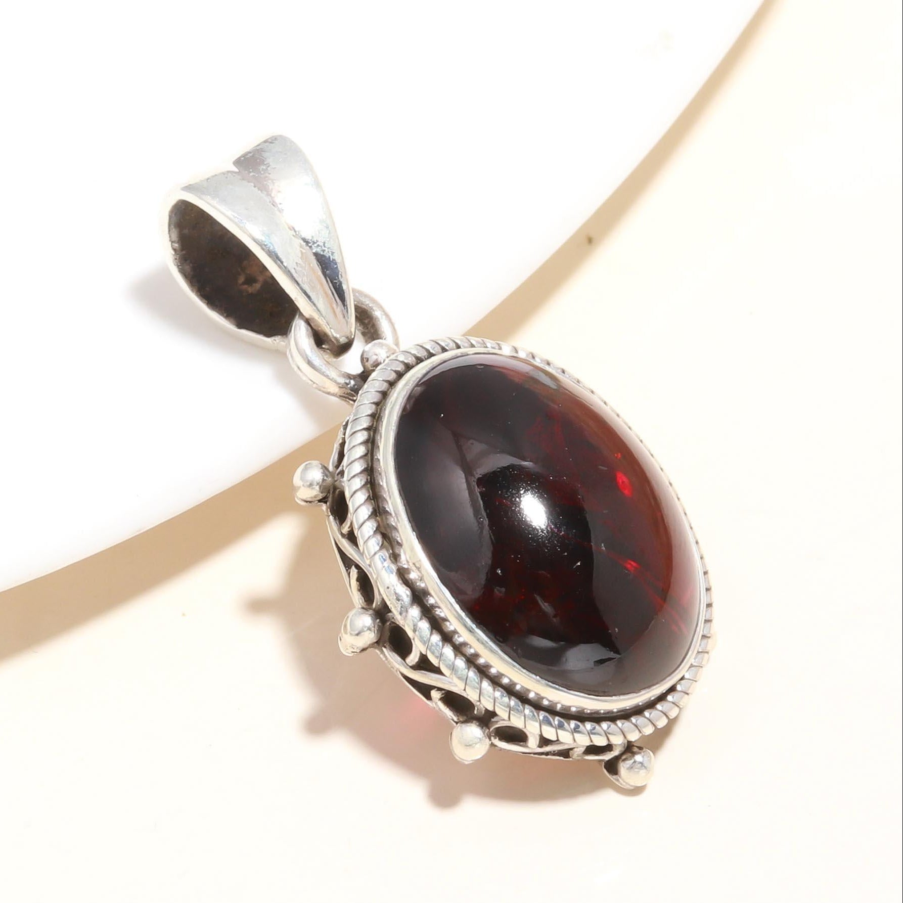 A 925 Sterling Silver Red Garnet Gemstone Pendant with a vintage-inspired design, displayed against a white background.