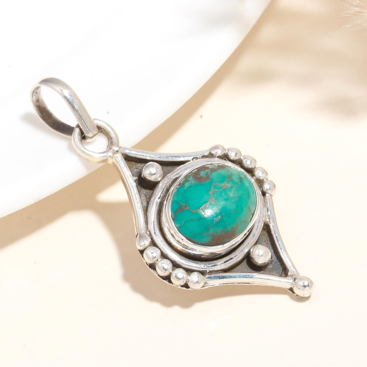 A 925 Sterling Silver pendant with a natural turquoise gemstone, featuring a handmade boho-inspired design with intricate silverwork.