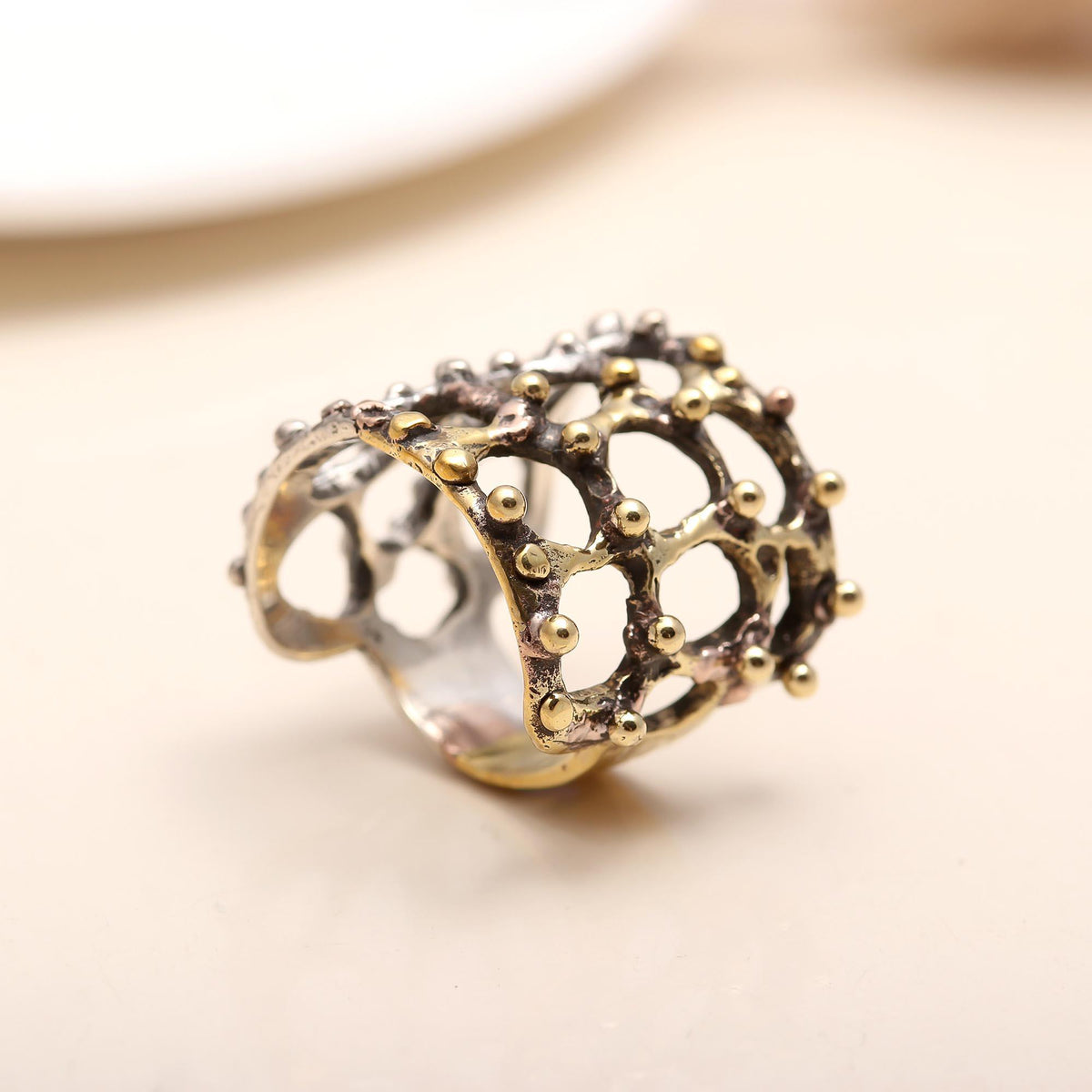 Dual-tone silver ring with gold accents