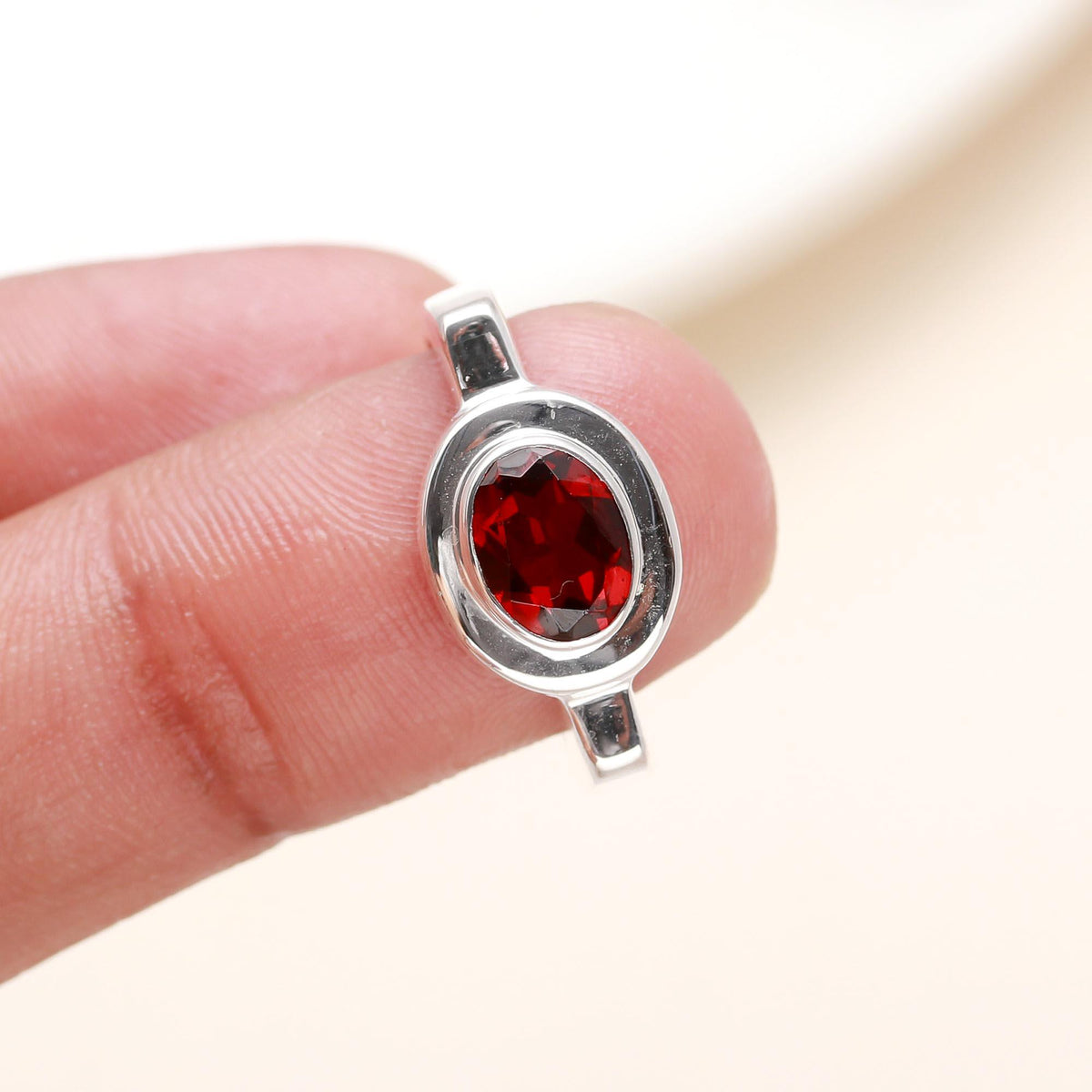 Elegant oval garnet ring on finger